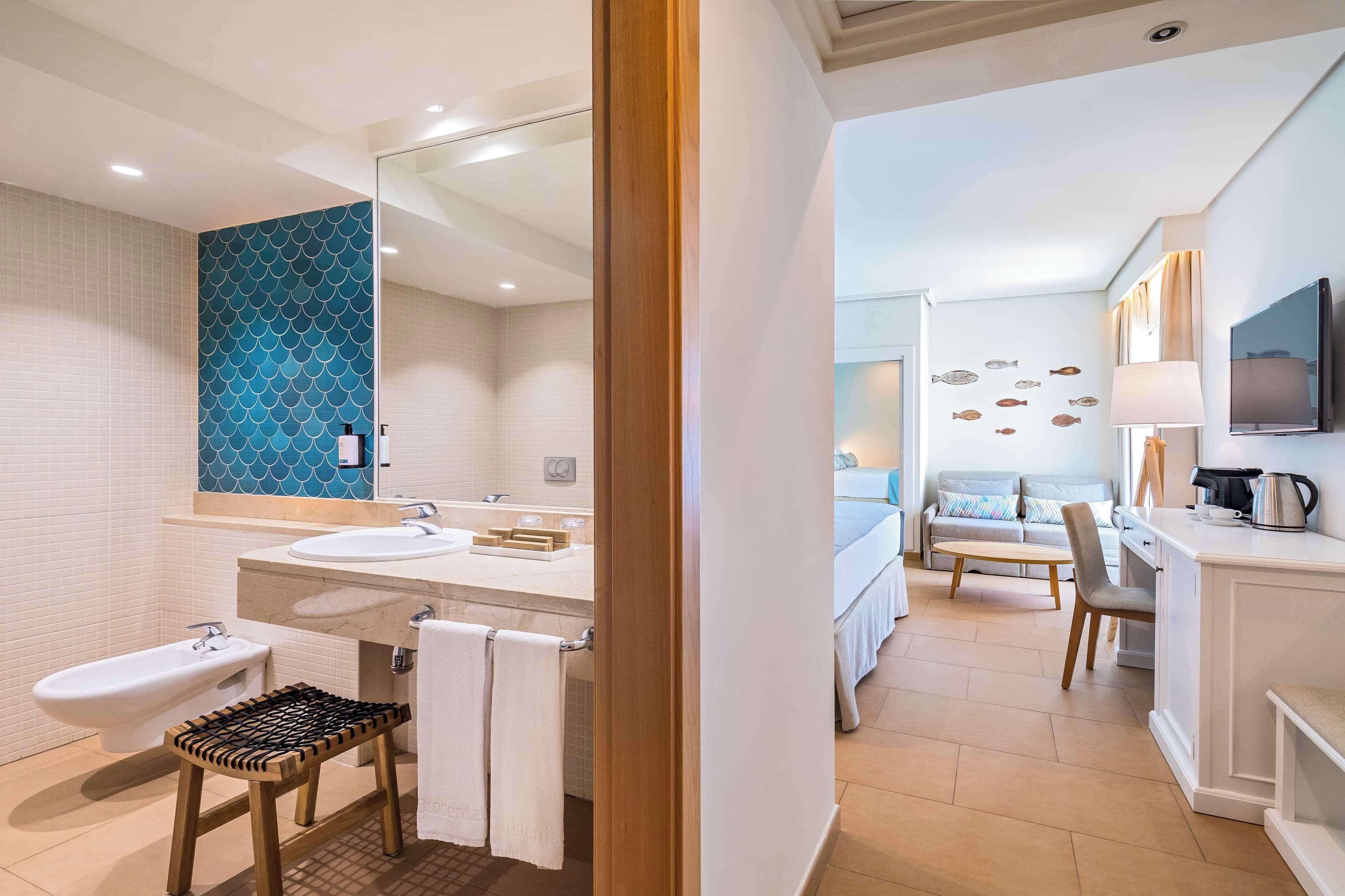 A modern bathroom with two sinks, a bidet, and a wooden stool.