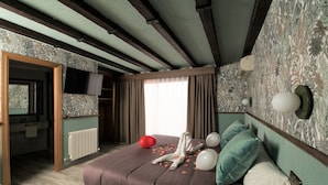 A bedroom with a large bed, a television mounted on the wall, and a bathroom visible through an open door. - Hotel Sol (Toledo)