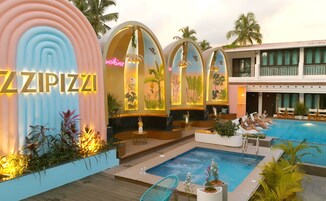 A pool area with a sign reading "ZZZIPIZZA," a hot tub, lounge chairs, and a poolside bar.