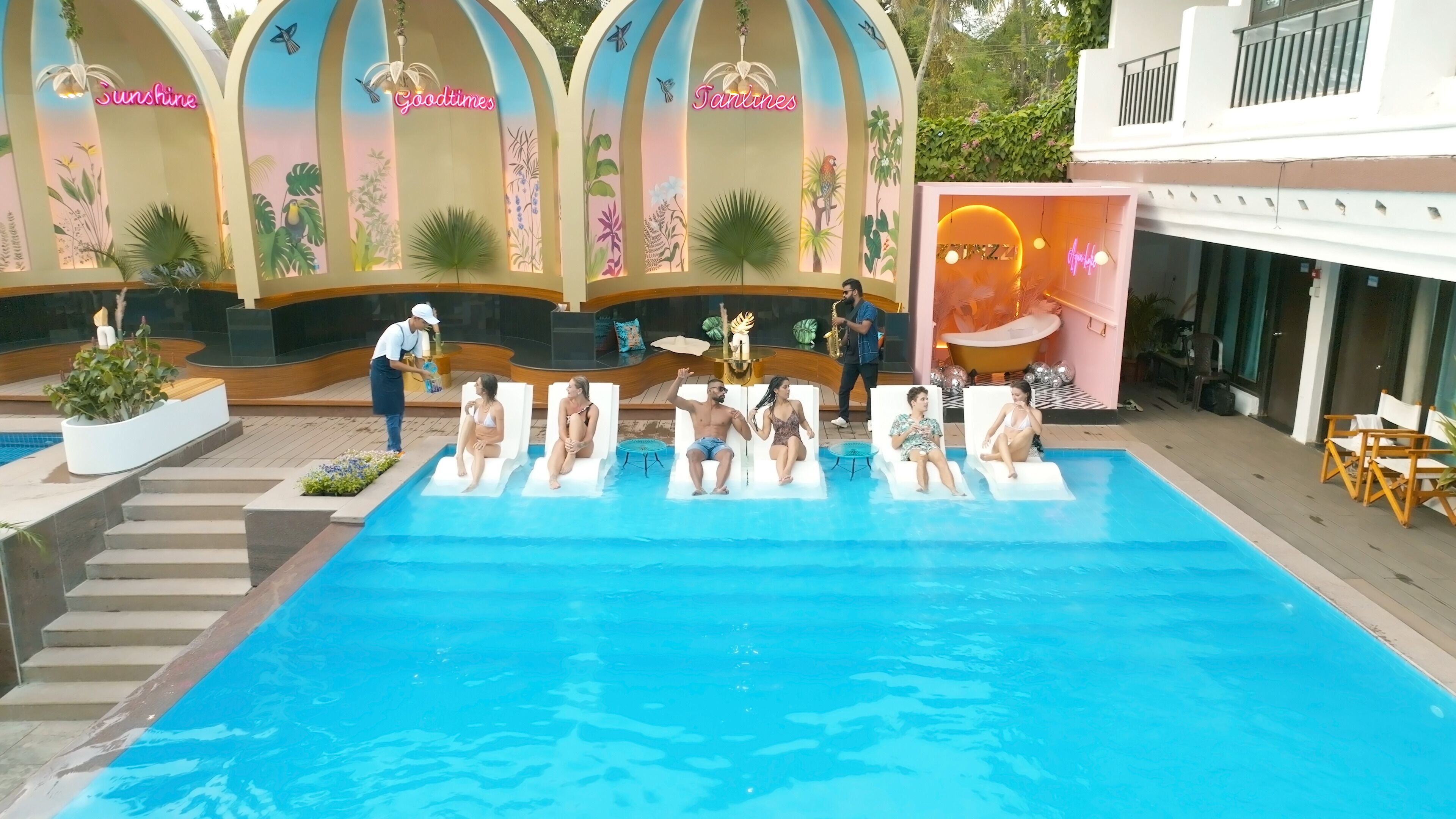 A pool area with lounge chairs and a poolside bar.
