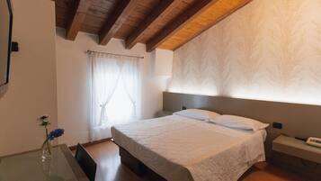Une chambre à coucher avec un lit, une table de chevet et une commode.