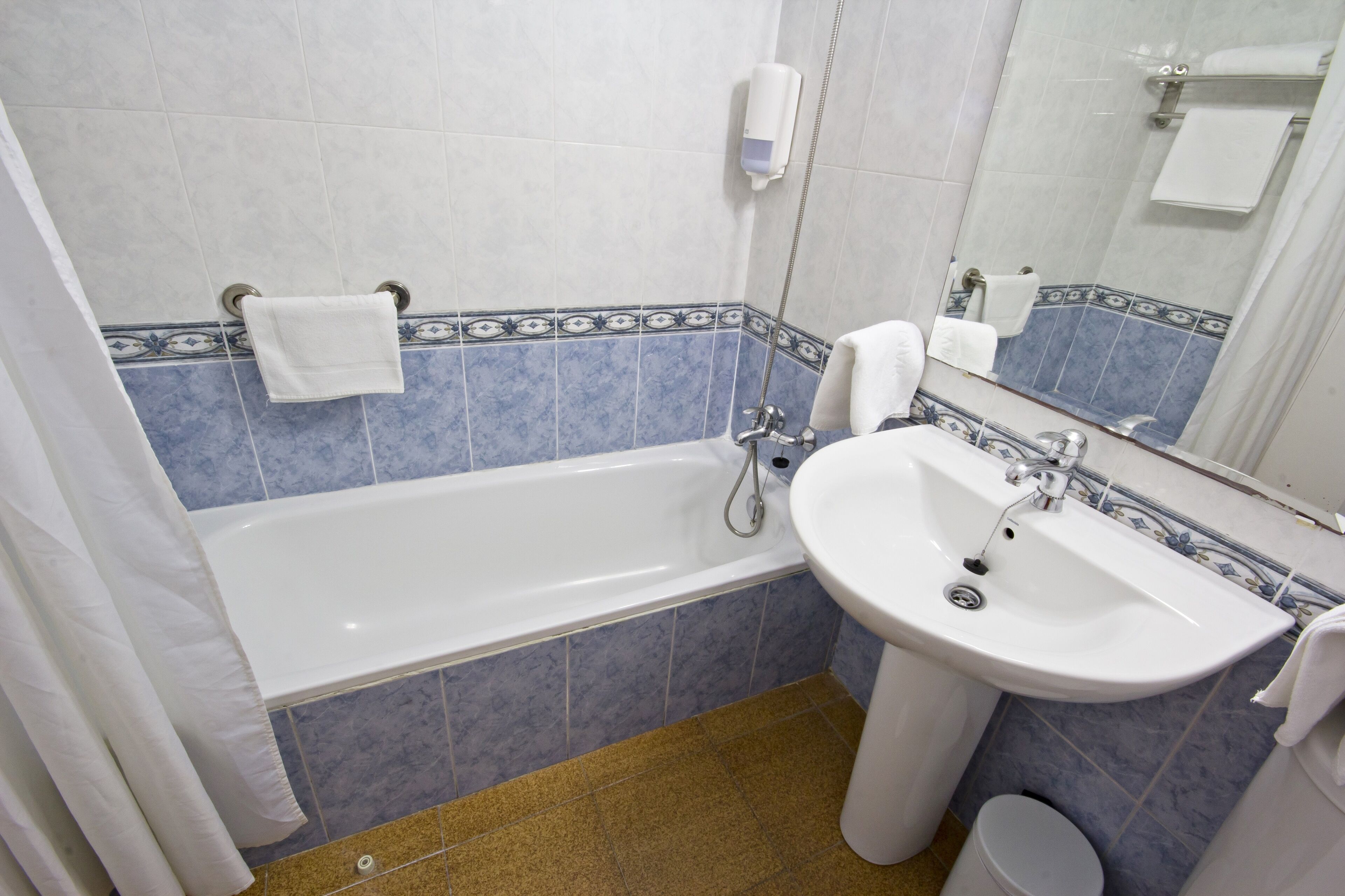 A bathroom with a bathtub, a sink, and a toilet.
