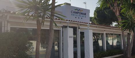 Entrada de un hotel con un cartel que dice "Campomar Hotel Playa".