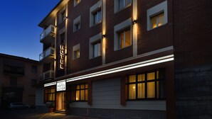 A hotel with a modern facade, multiple balconies, and a sign indicating it is the Hotel Astor. - Hotel Astor (Bologna)