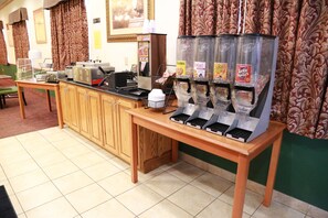 A breakfast bar with a coffee machine, a toaster, and a cereal dispenser.