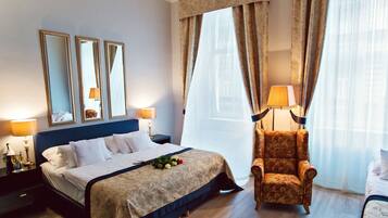A hotel room with a large bed, two bedside lamps, a chair, and a window with curtains.