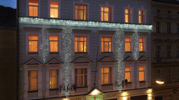 A hotel with a classic facade, multiple windows, and a ground-floor entrance.