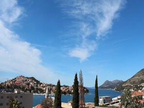 A coastal town with buildings, a church, and a clear blue sky. - Berkeley Hotel (Dubrovnik)