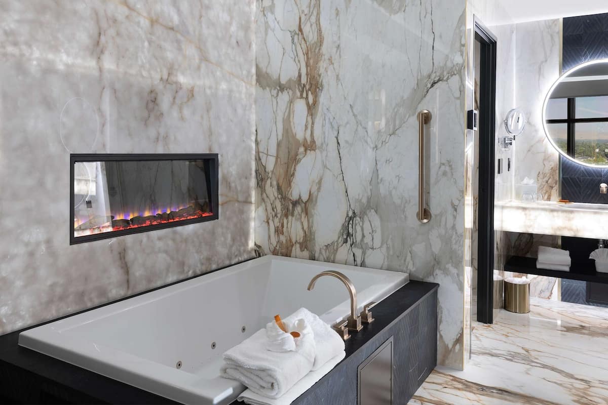 penthouse suite, 1 king bed, smoking, jetted tub (separate living room) | premium bedding, in-room safe, desk, laptop workspace