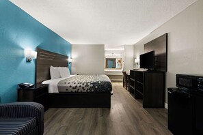 A hotel room with a bed, a desk, a TV, and a microwave. - Rodeway Inn Richmond West End (Richmond)