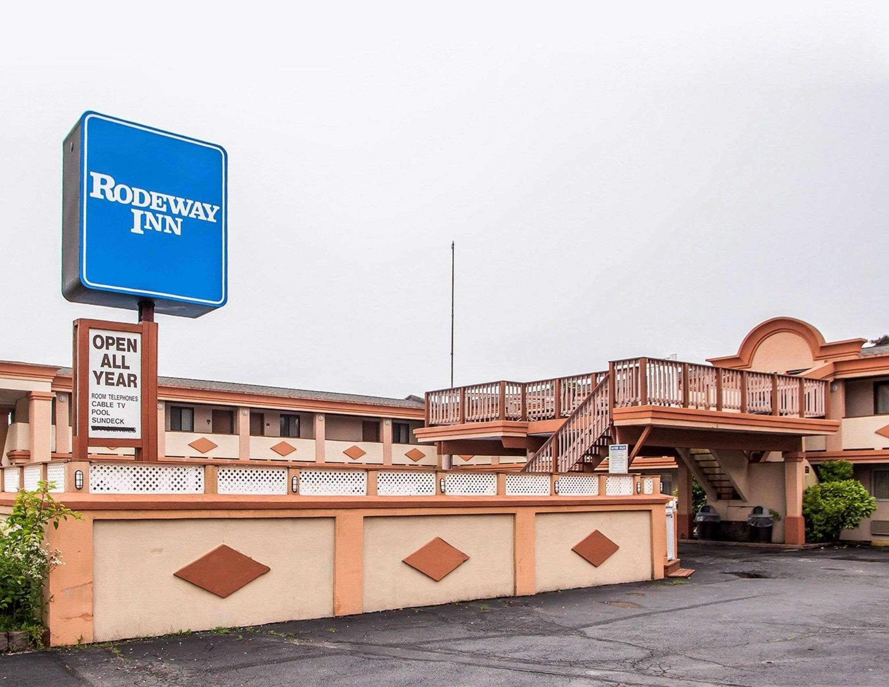 A motel with a prominent sign reading "RODEWAY INN" and an additional sign stating "OPEN ALL YEAR".