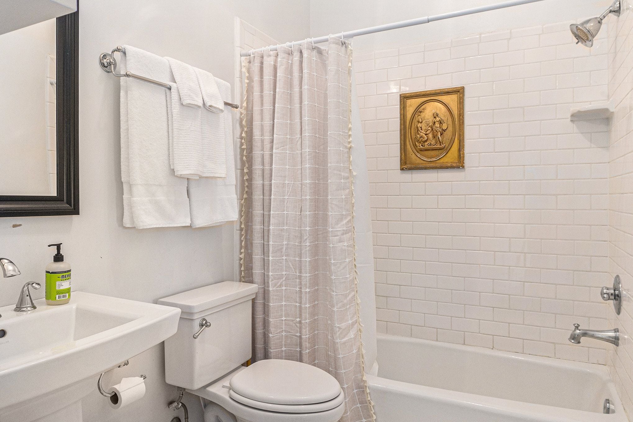A bathroom with a toilet, sink, and bathtub.