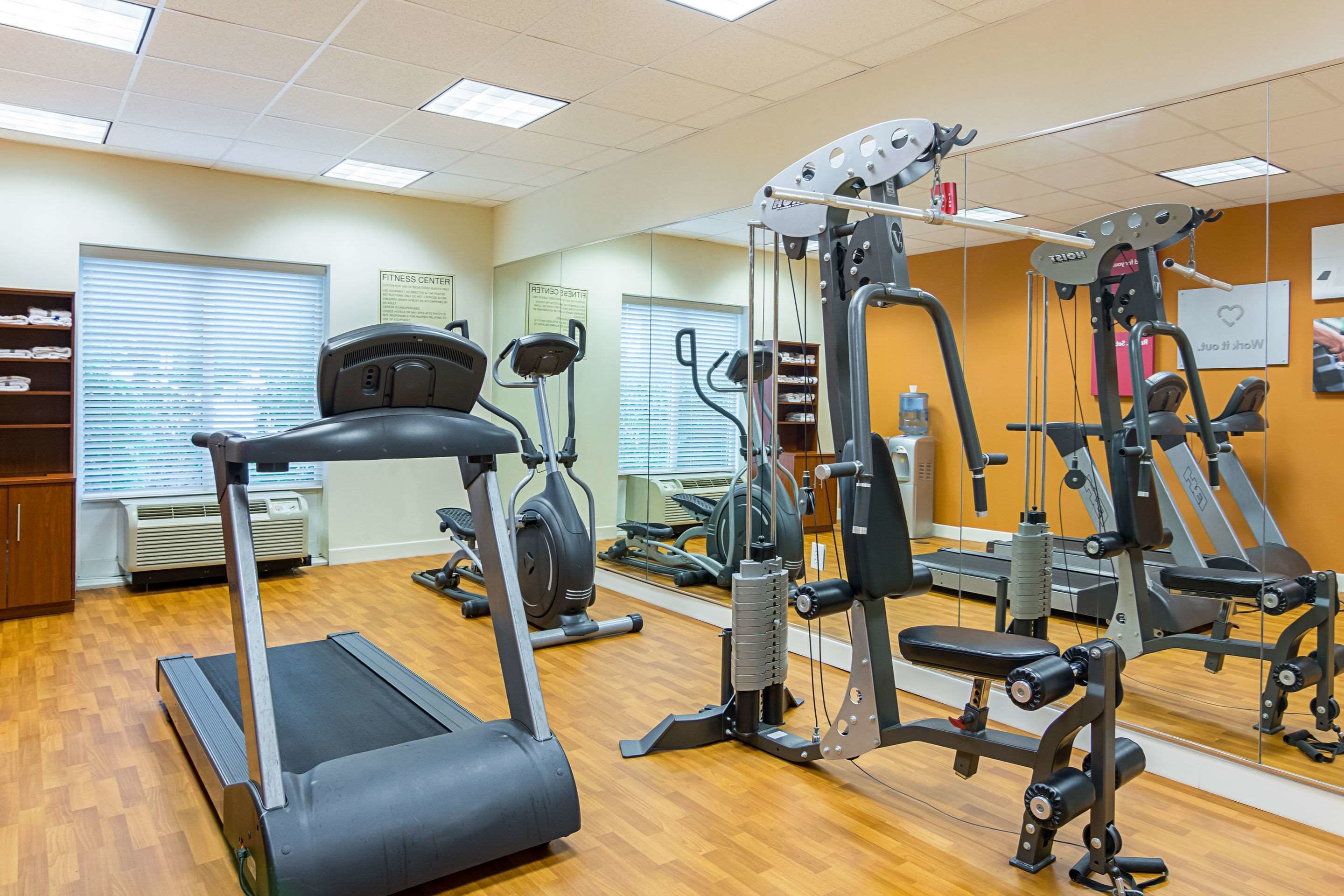 A fitness center with treadmills, elliptical machines, and weightlifting equipment.