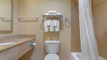 A bathroom with a toilet, sink, and shower curtain.