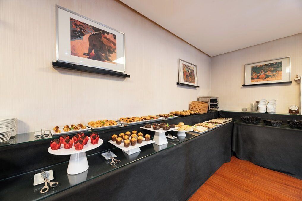 A buffet setup with various food items and a glass display case.