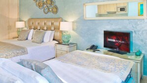 A hotel room with two beds, a television, a desk with a telephone, and a wall-mounted mirror. - El Oceano Beach (Mijas)