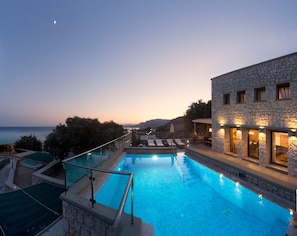 Outdoor pool, a heated pool, pool umbrellas, pool loungers