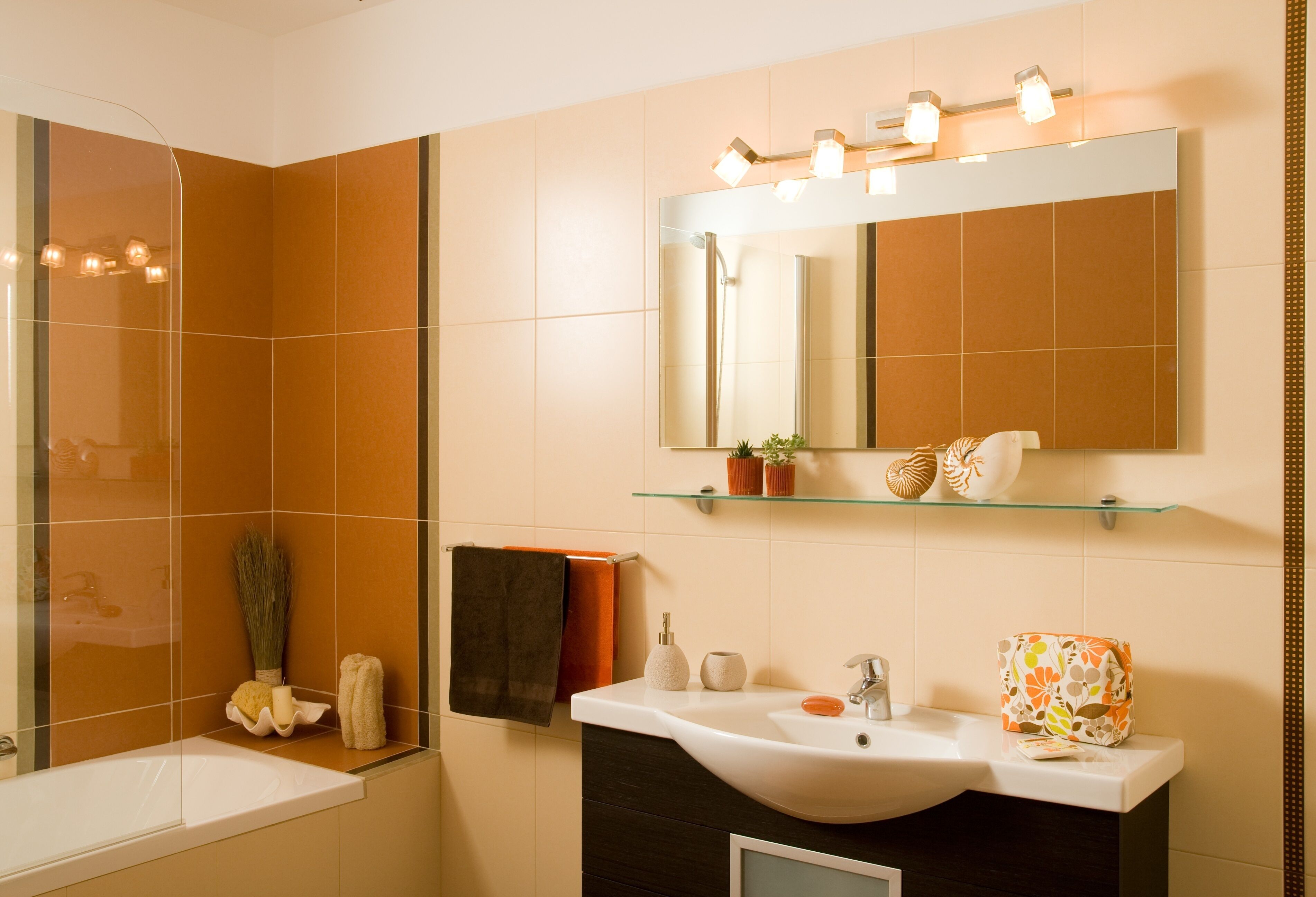 A modern bathroom with a bathtub, a sink, a mirror, and a shower.