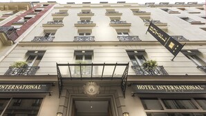 The facade of Hotel International in Paris, featuring a symmetrical design with balconies, large windows, and a prominent entrance. - Hôtel International Paris (Paris)