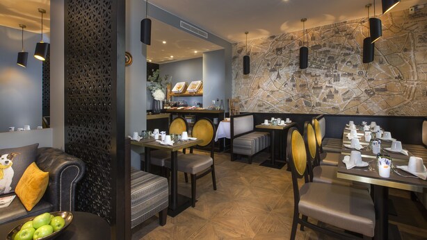 A restaurant with a modern interior, featuring a map wall, black pendant lights, and a variety of seating options including booths and tables. - Hôtel International Paris (Paris)