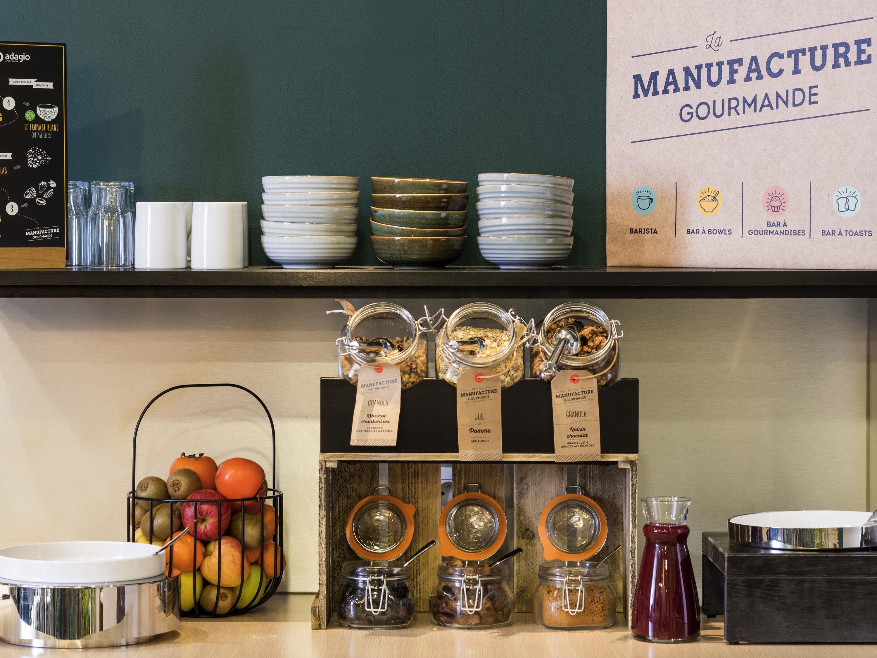 A breakfast bar with various food items and utensils.