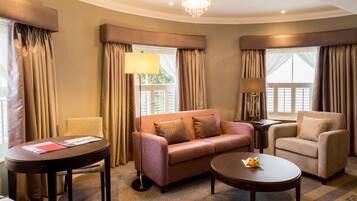 Suite, 1 King Bed (Four Poster Suite) | Living area | Smart TV, books