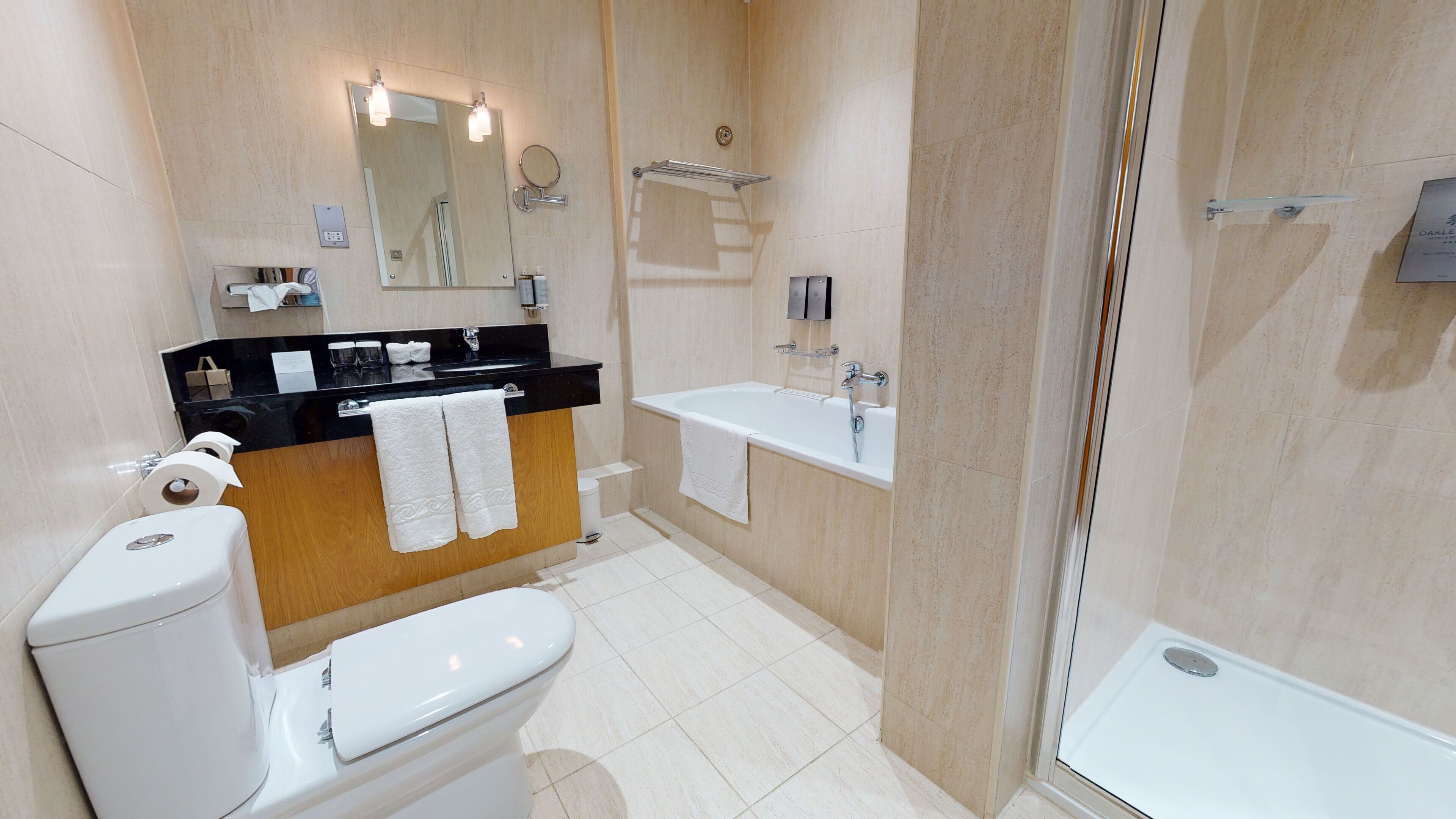 A modern bathroom with a toilet, sink, and bathtub.