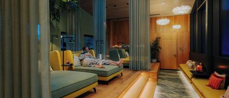 A modern living room with sofas, a coffee table, and a large window.