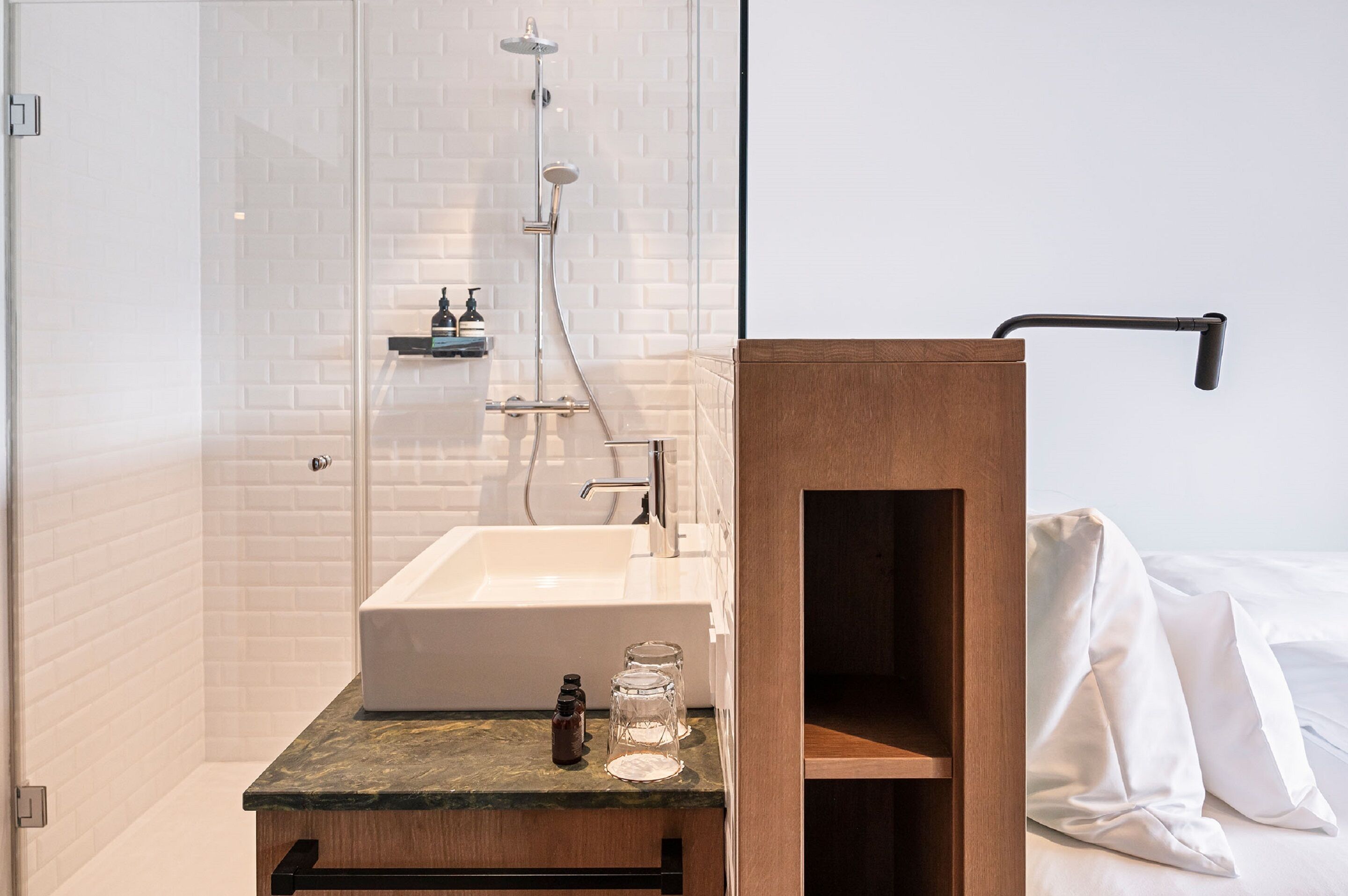 A modern bathroom with a freestanding bathtub, a glass shower enclosure, and a wooden vanity with a sink.