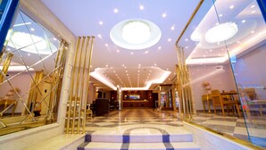 A hotel lobby with a checkered floor, a reception desk, and a staircase leading to upper floors. - Aspen Hotel Istanbul (Istanbul)