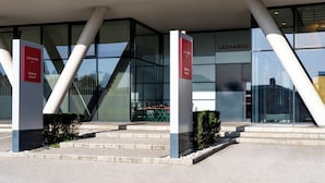 A modern building with glass windows and a sign for 'Leonardo Salzburg Airport'. - Leonardo Hotel Salzburg Airport (Wals-Siezenheim)