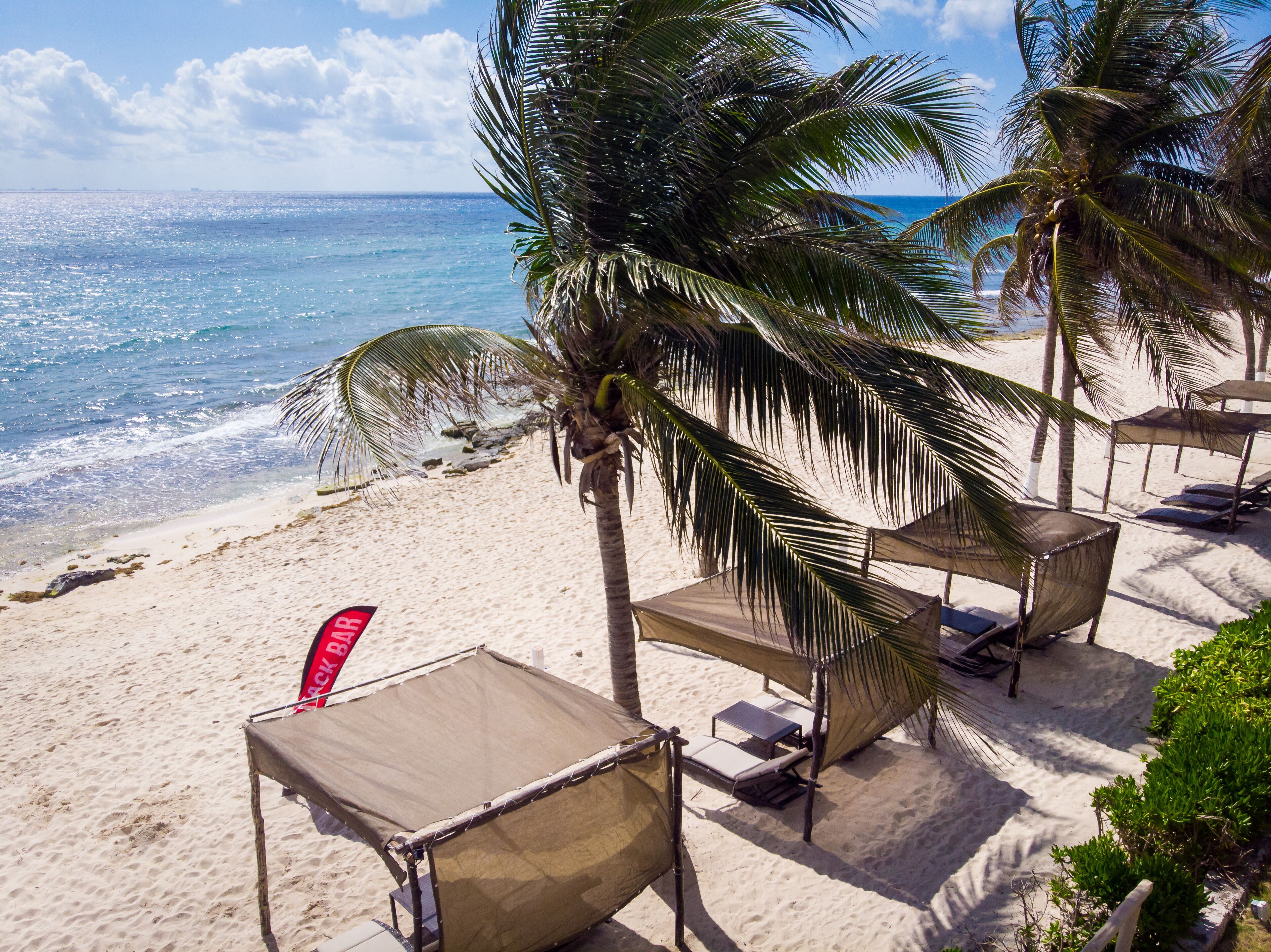On the beach, white sand, sun loungers, beach umbrellas
