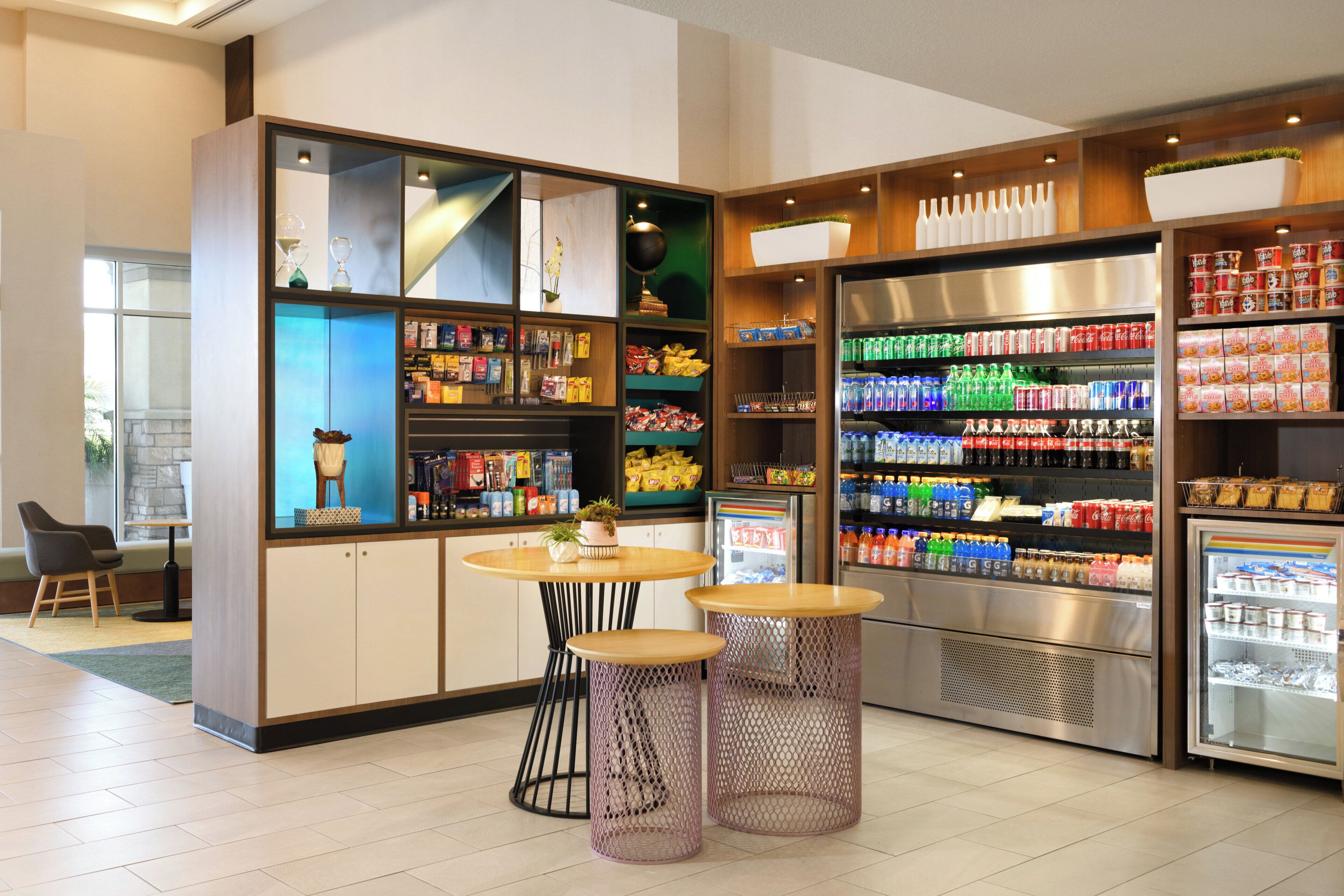 A self-service beverage station with refrigerated drinks and snacks.