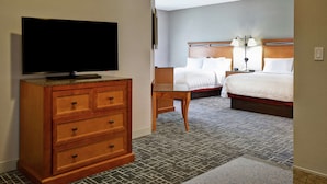 A hotel room with a wooden dresser, a television, two beds, and a carpeted floor. - Hampton Inn & Suites Salt Lake City-West Jordan (West Jordan)