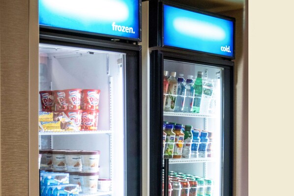 Two refrigerated display cases with labels indicating 'frozen' and 'cold' sections, containing various food and beverage items.