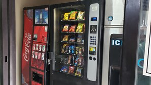 A vending machine with various snacks and drinks, including Doritos and Coca-Cola.