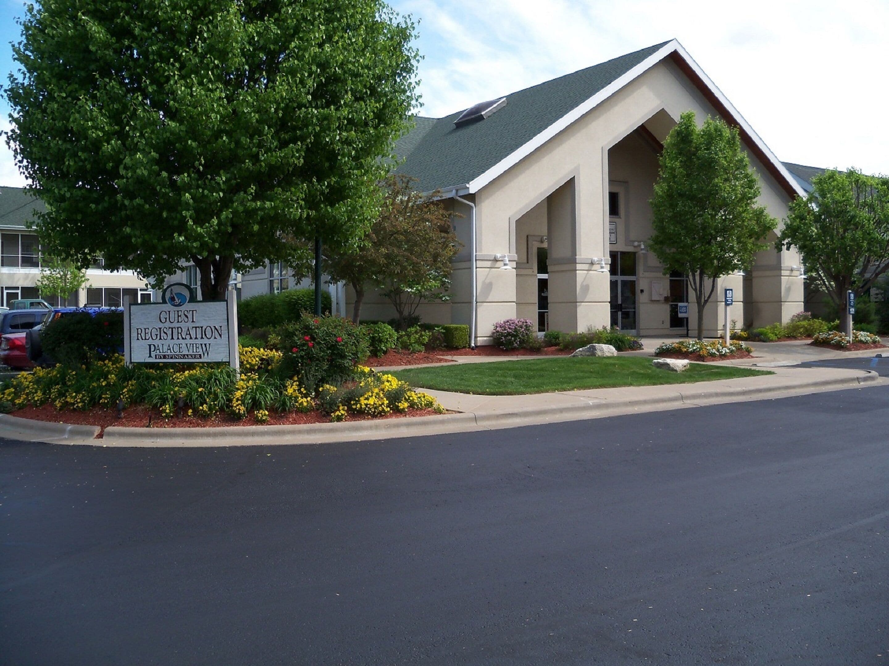 A building with a sign for 'Guest Registration' and 'Palace View' by Spinnaker.