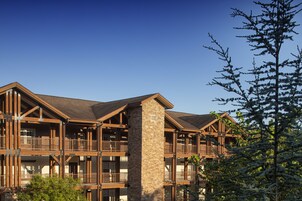 A multi-story building with a stone facade and wooden balconies.