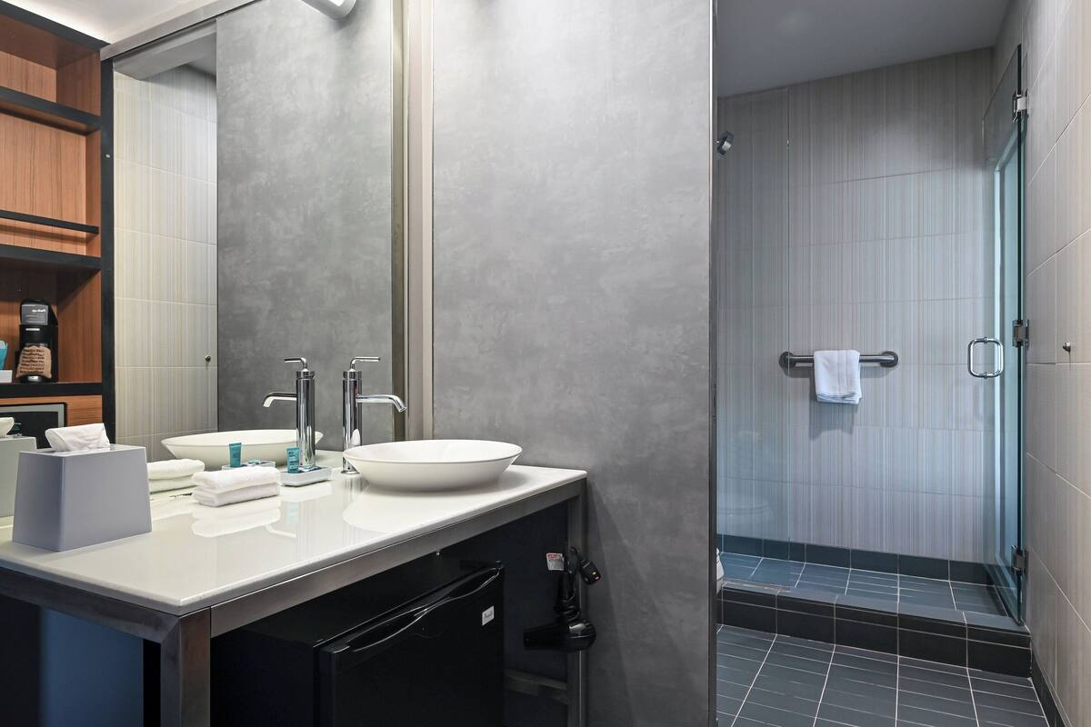 rainfall showerhead, designer toiletries, hair dryer, towels