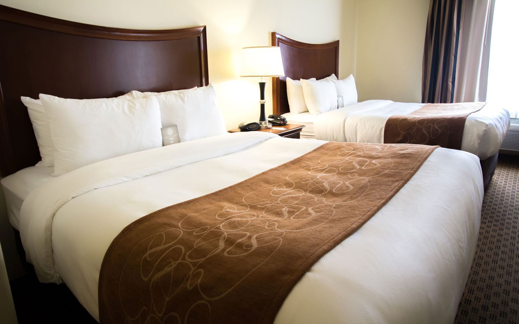 Premium bedding, pillow-top beds, desk, laptop workspace