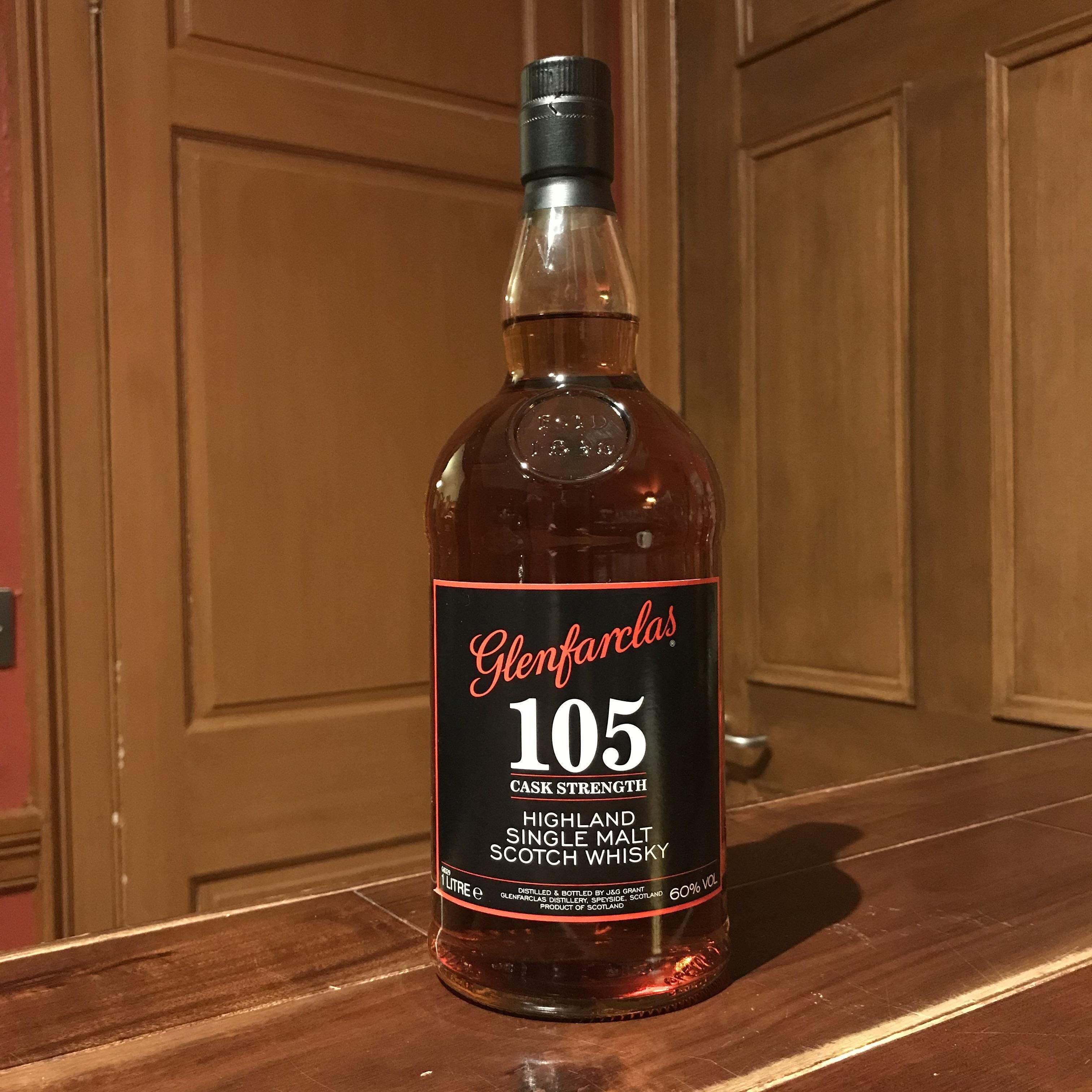 A bottle of Glenfarclas 105 single malt Scotch whisky on a wooden surface.