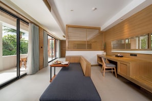 A modern kitchen with a built-in bench, a dining table, and a window with blinds.