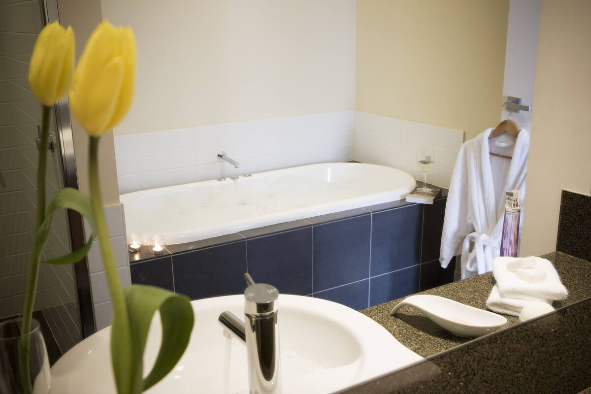 designer toiletries, hair dryer, towels, soap