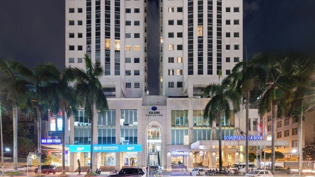 A high-rise hotel with multiple floors, a prominent entrance, and a well-lit facade.