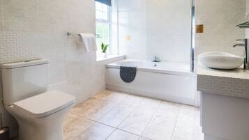 Un baño moderno con inodoro, bañera y lavamanos.