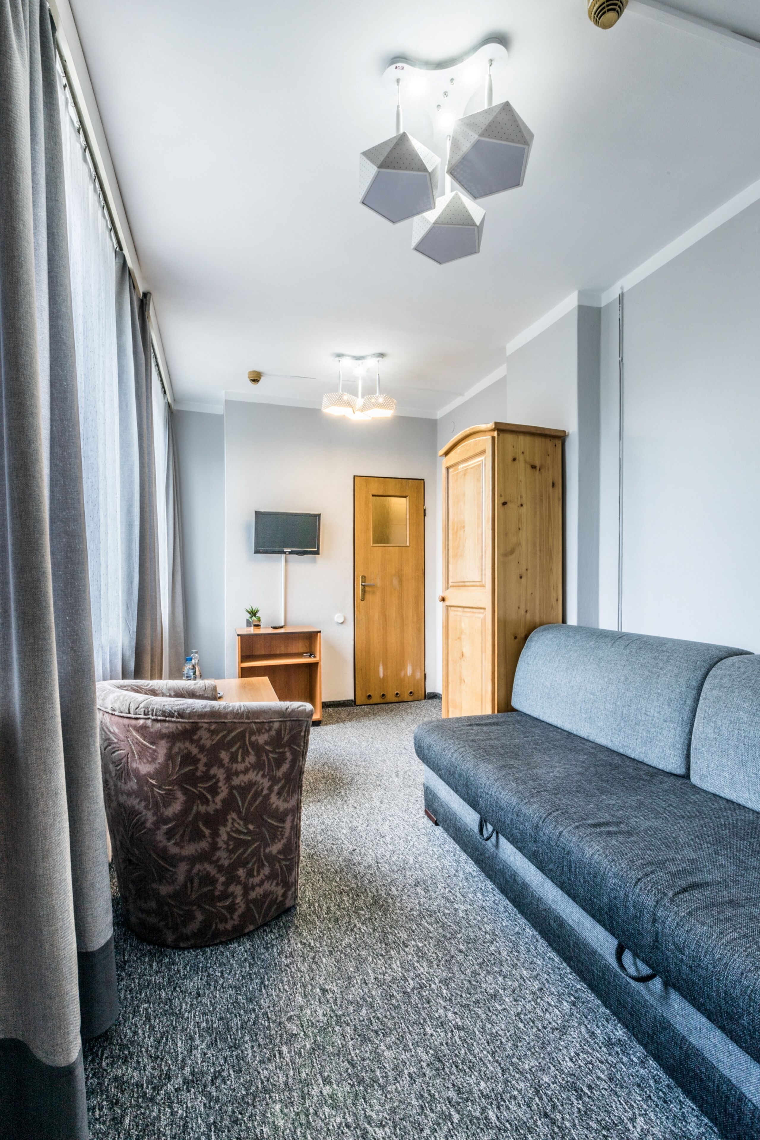 small double room with small bathroom (parking view) | living area | flat-screen tv