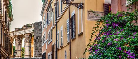 A narrow street with historic buildings, including a building with a sign reading "DEGL'IBERNE."
