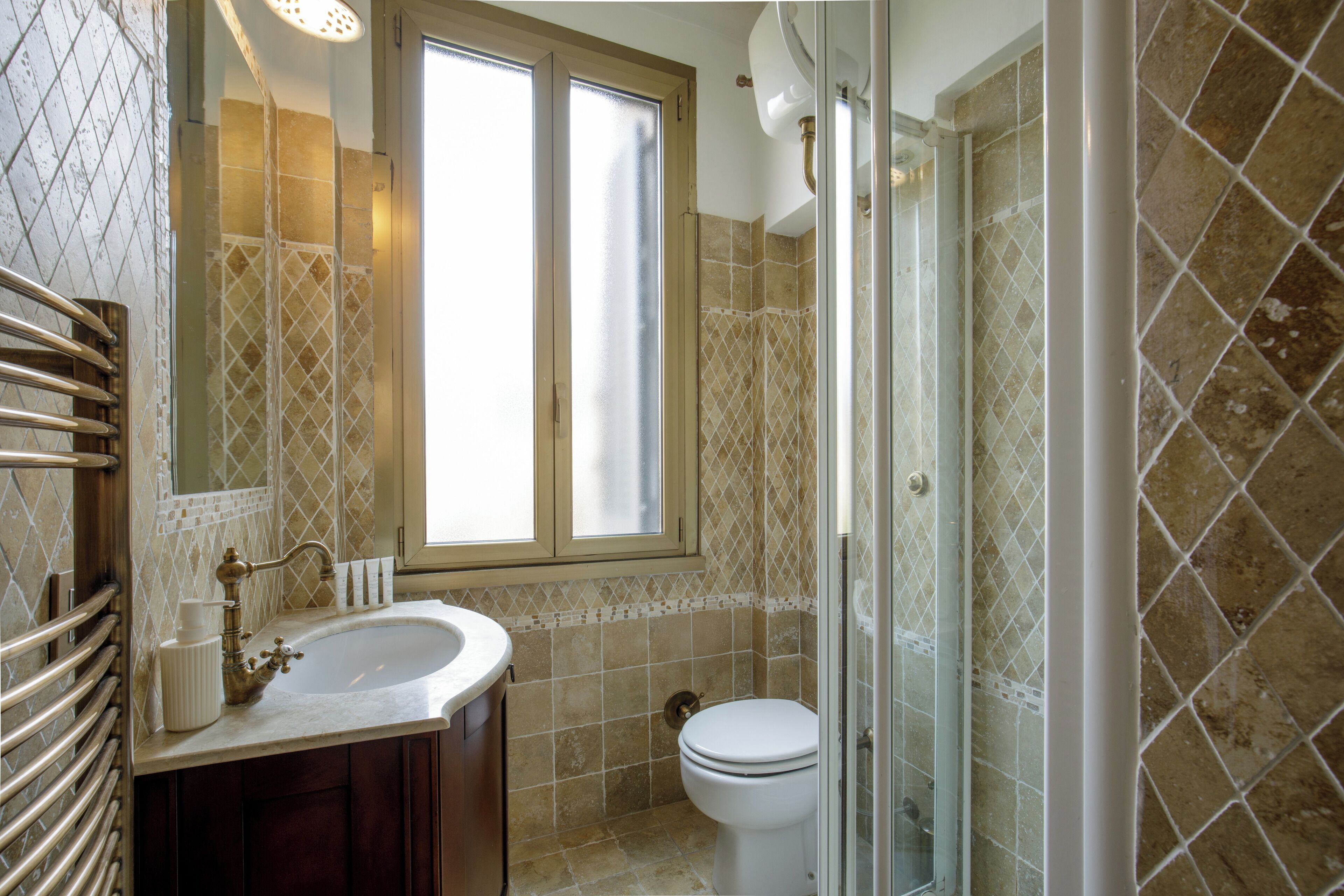A bathroom with a sink, toilet, and shower.