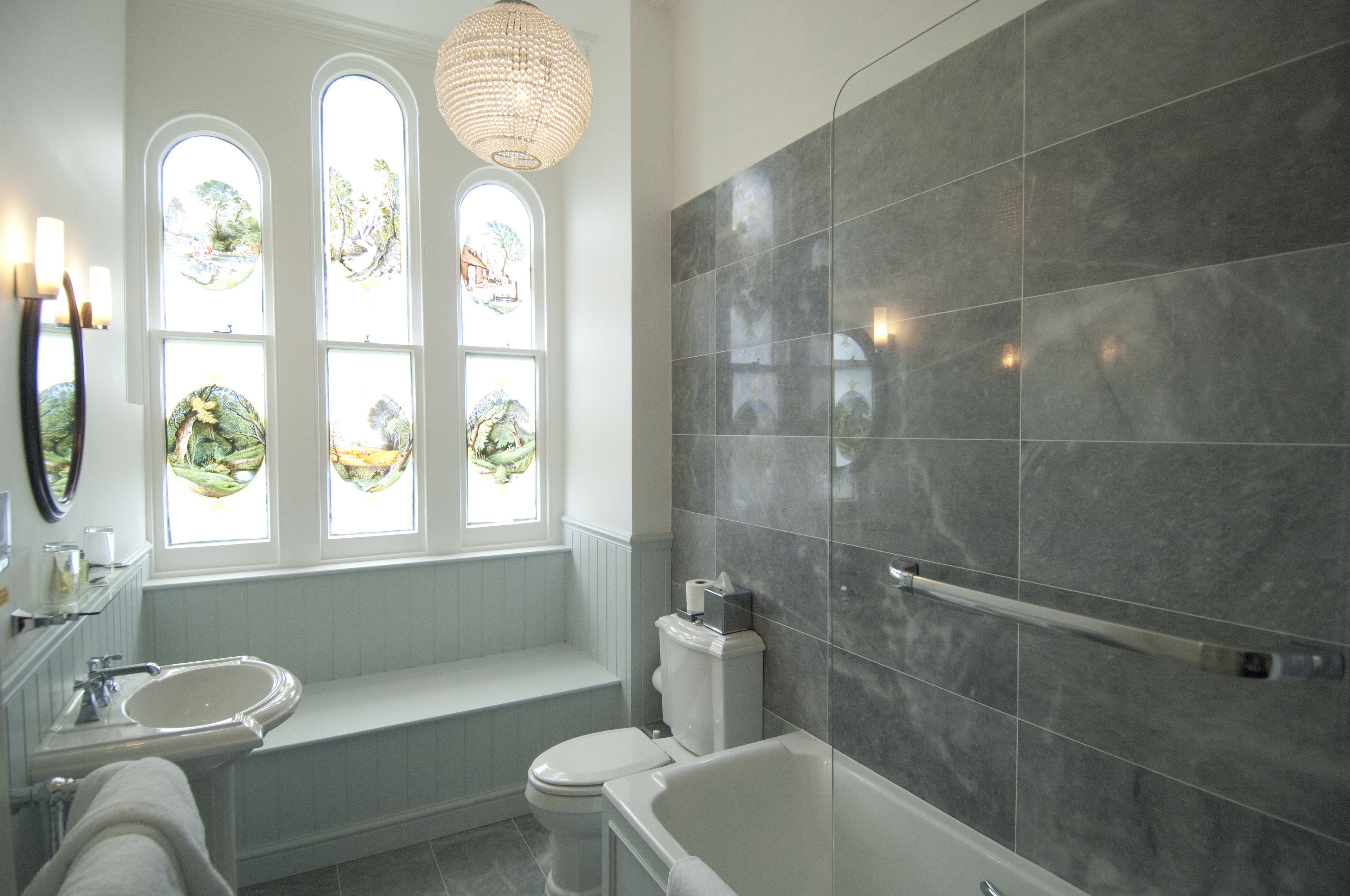 combined shower/bathtub, designer toiletries, hair dryer, bathrobes