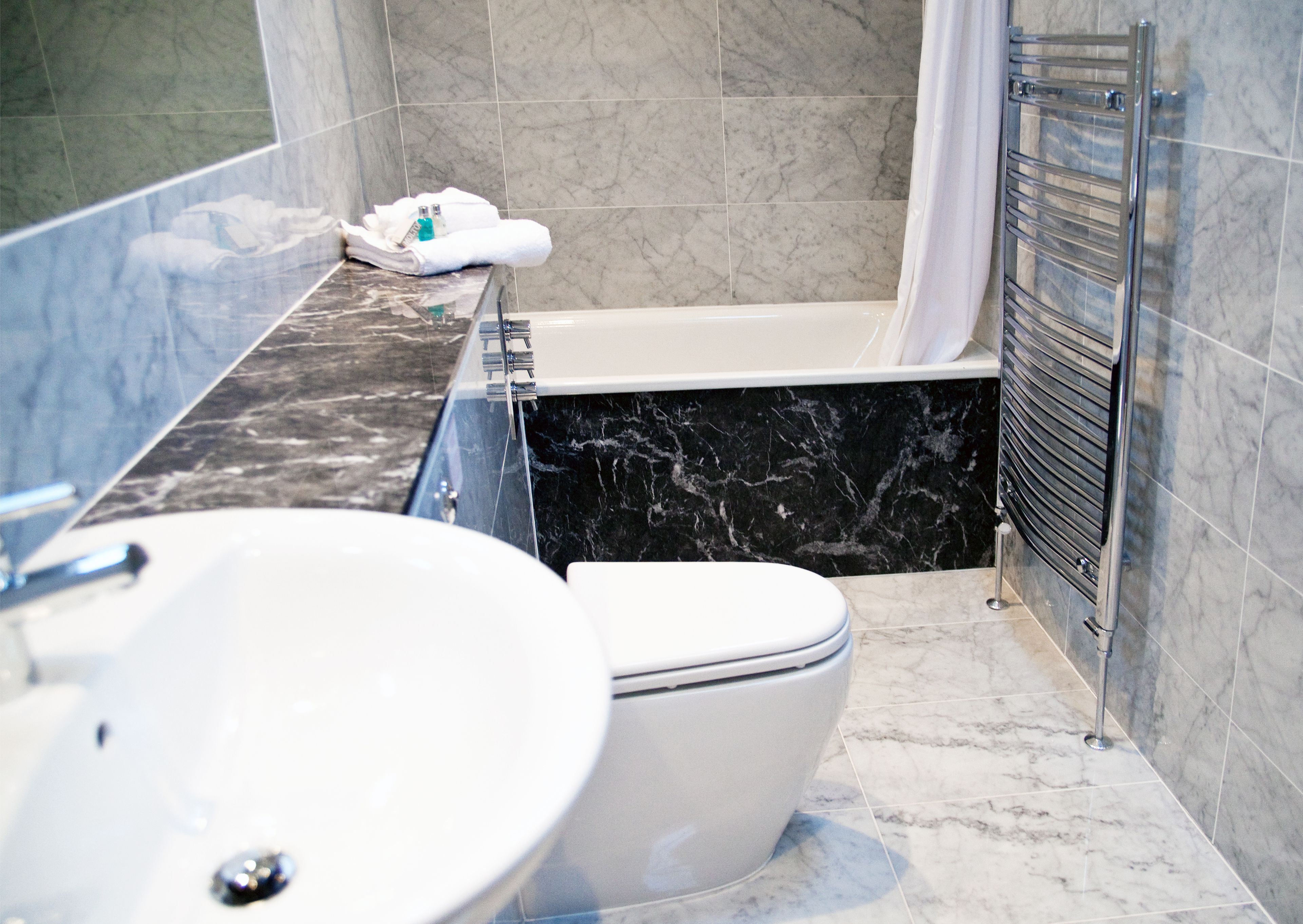 combined shower/bathtub, designer toiletries, hair dryer, bathrobes